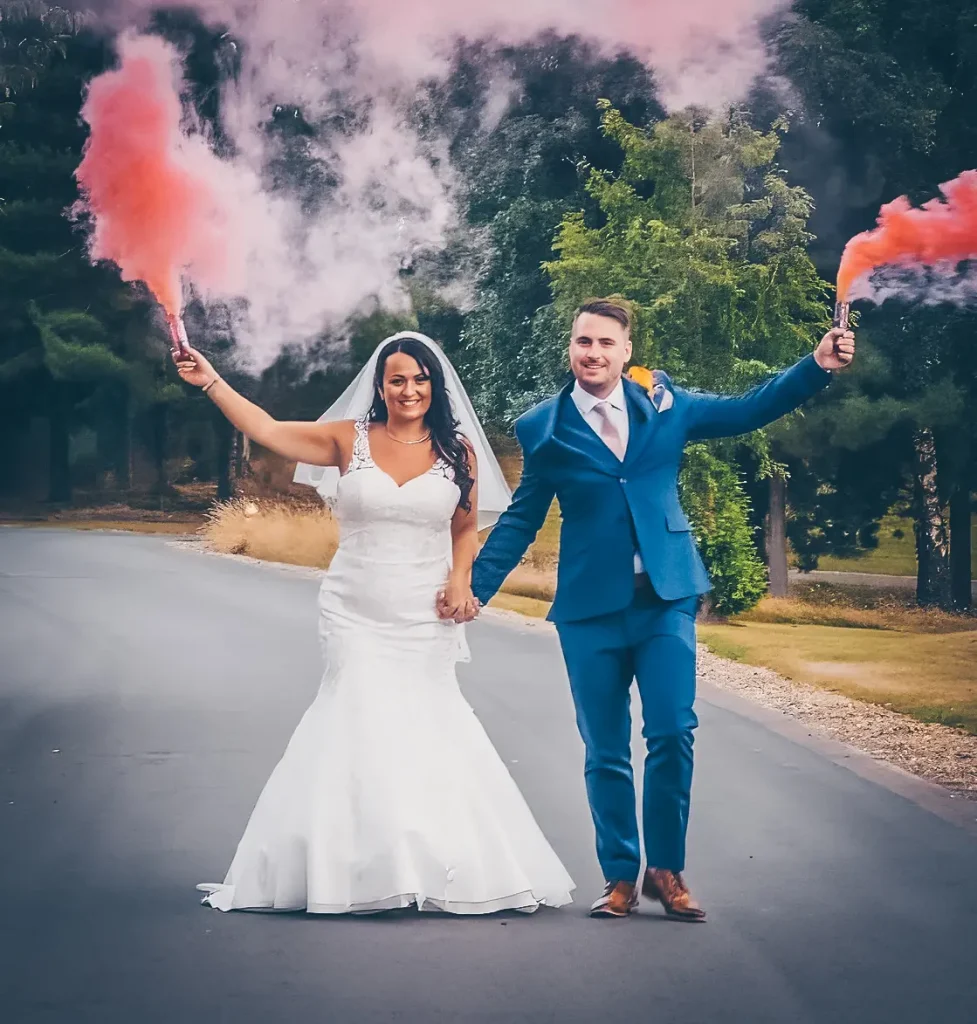 Norfolk Wedding Videographer Bride & Groom walking along with red and blue flares